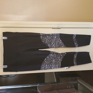 Black yoga/exercise pants with lace pattern around knees.